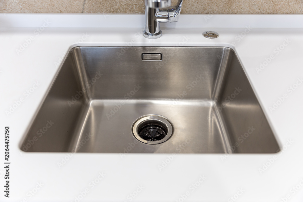Fototapeta premium Stainless kitchen sink with food waste disposal in modern home