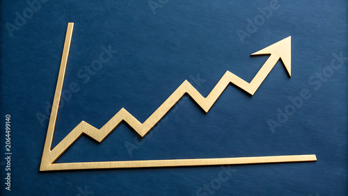 Gold colored line graph showing an upward trend with a rising arrow on a dark blue textured background, symbolizing financial growth