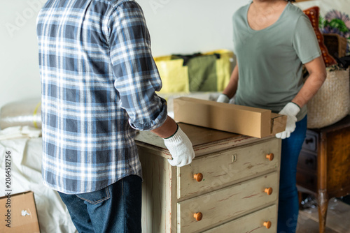 Photography Couple moving furniture together photo