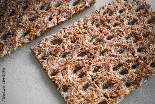 Konstfotografi Crispbread slice on white background in clean minimalist food composition