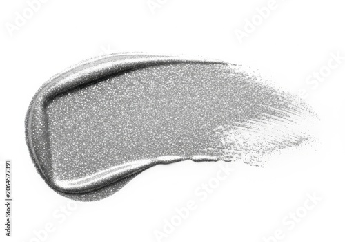Silver metallic cosmetic cream swatch during bright studio lighting with selective focus