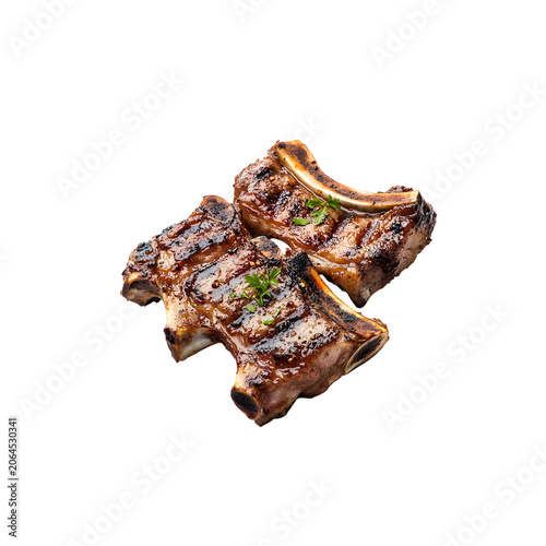Two grilled bone in pork chops seasoned with herbs