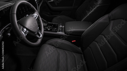 Dark interior features sleek, black leather seats