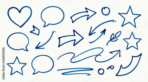 Various hand-drawn blue marker doodle elements on a white paper background.