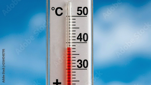 Outdoor thermometer showing 40 degrees Celsius extreme heat summer blue sky photo