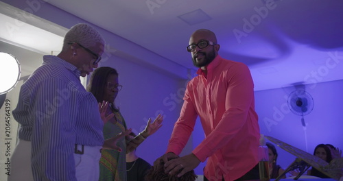 Konstfotografi Man in bright shirt blesses kneeling boy during church service while preacher an