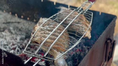 Grilling Fresh Dorado Fish on Outdoor BBQ Close Up