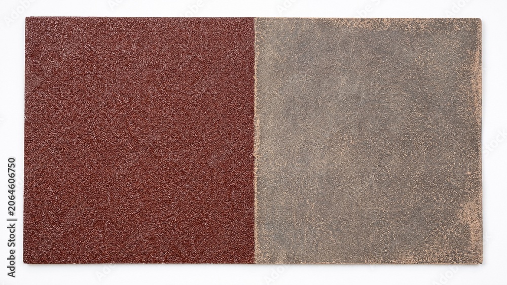 Fototapeta premium Sandpaper sheet comparison, one side pristine rough and the other worn smooth.