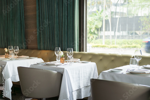 Upscale Dining Room with Natural Light and Elegant Table Settings
