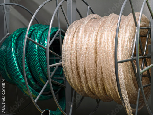 Fotografia Green and transparent hoses wound into neat coils are available in a hardware st
