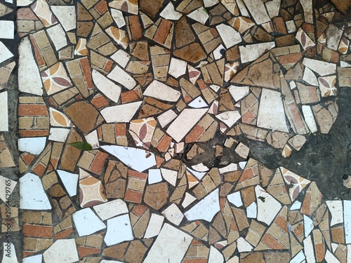 Obraz na plátně Colorful broken ceramic tile mosaic floor with irregular shards in brown, orange