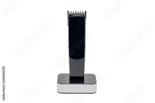 Wireless hair trimmer with steel blades on a charging station, cut-out graphic
