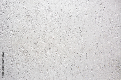 White plaster wall texture with subtle rough pattern and decorative finish. Clean architectural background suitable for design, construction, renovation, and graphic projects.