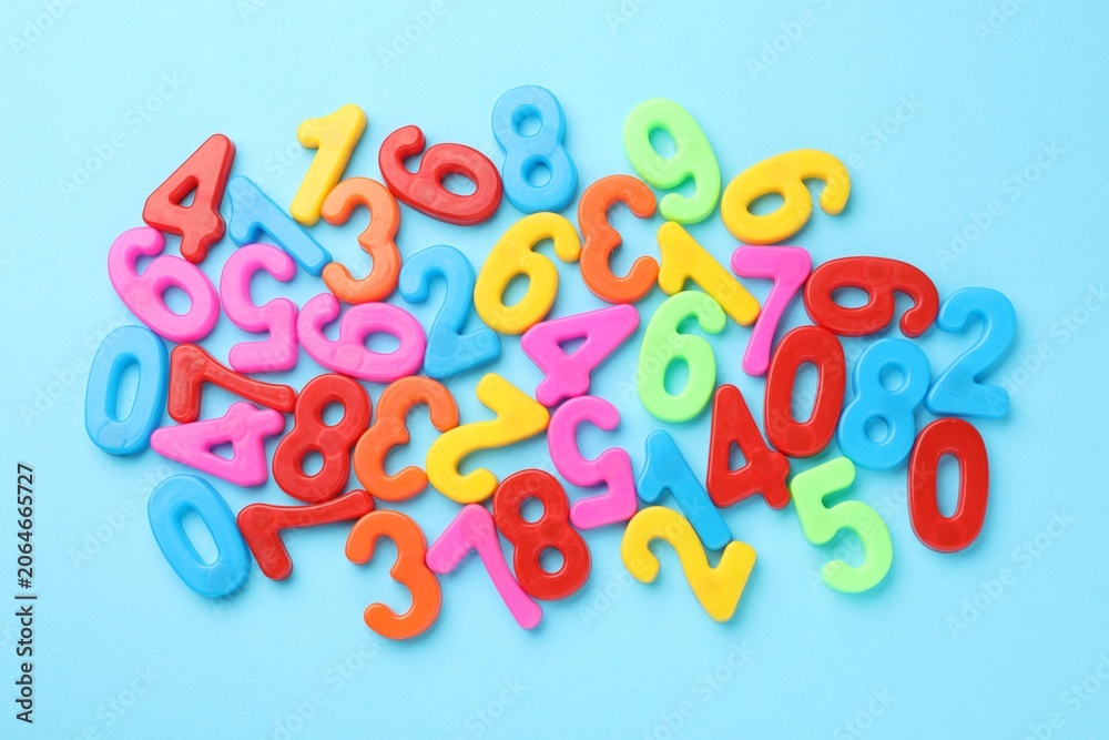 Fototapeta premium Colorful numbers on light blue background, flat lay