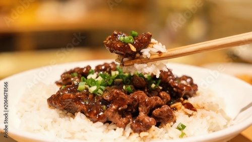 Beef with rice and chopsticks
