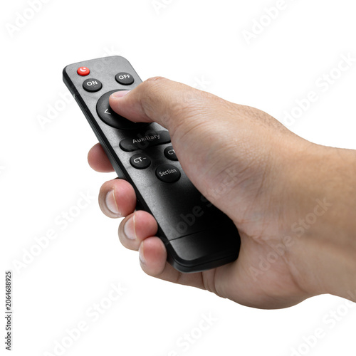 Close-up of hand holding black multi-function remote control, isolated on white background