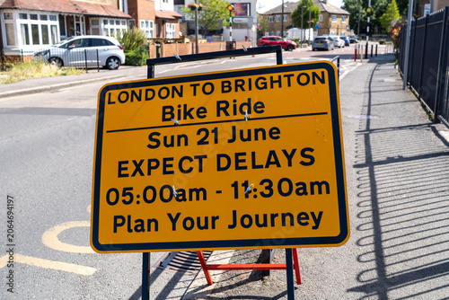 Photography Yellow road sign warning of london to brighton bike ride delays on sunday june 2