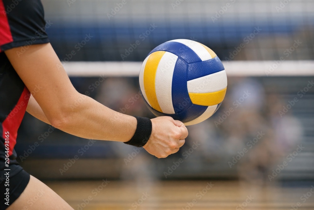 Naklejka premium A person grasping a volleyball ball in their hand