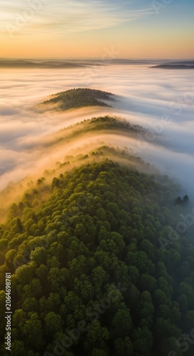 Misty Morning Sunrise Over Forested Hills Aerial View.