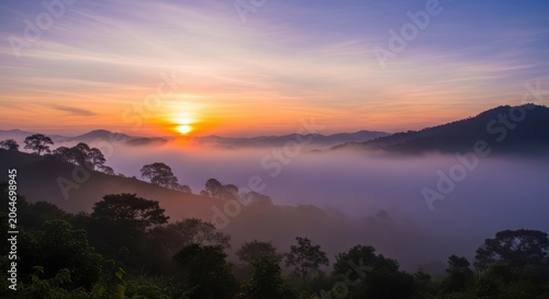 Misty Mountain Sunrise Over Lush Green Forest Canopy.