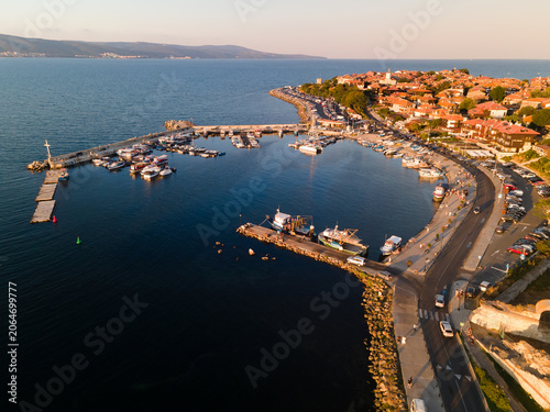 Aerial view of the marina with boats and yachts in old town of Nessebar, old church and houses, located in the Sunny Beach area of Bulgaria. Drone view from above. Summer holidays destination