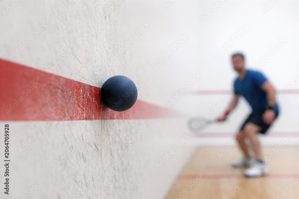 Obraz premium A person holding a racket standing on a wooden surface, suitable for sport or activity illustrations