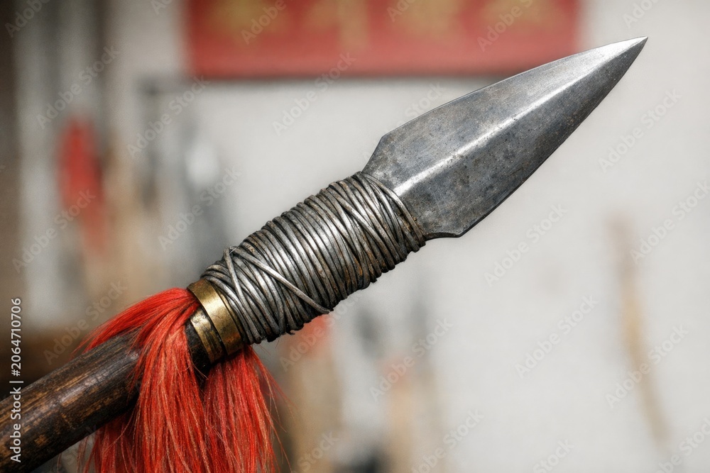 Naklejka premium A close-up shot of a knife with long, red hair tangled around its handle