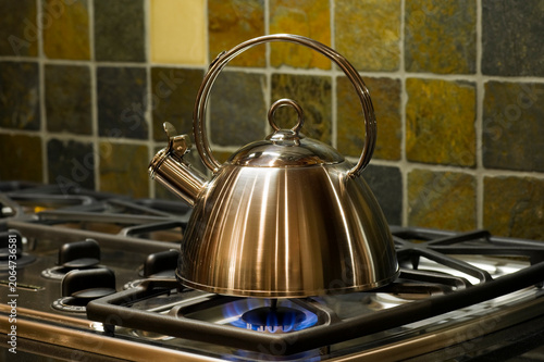 bronze copper tea kettle flame stove tile