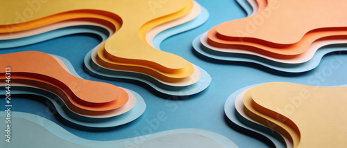 Abstract layered paper cutouts create a flowing, organic landscape with soft colors