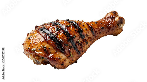 Grilled Jamaican jerk chicken drumstick with spicy sticky glaze isolated on black background