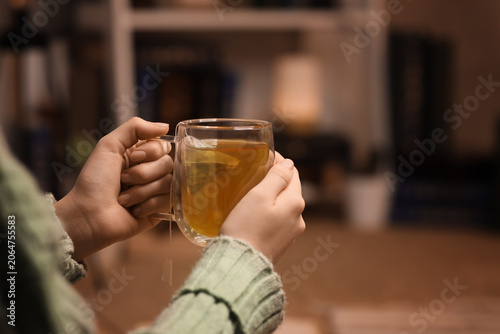 Konstfotografi Cozy warmth and relaxation with hot herbal tea in a clear glass mug, comforting