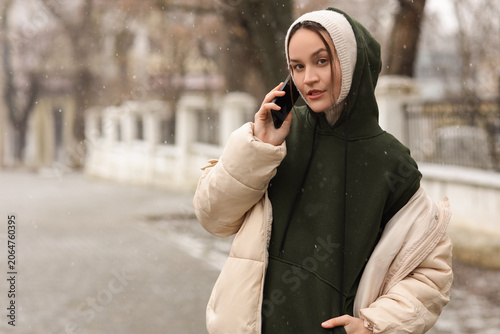 Young woman in hoodie with ...