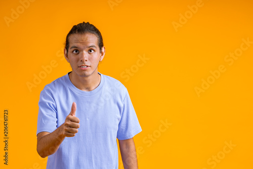 Tableau sur toile Young man giving approval with skeptical expression
