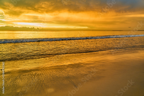 Golden Sunset Over Calm Ocean Waves and Sandy Beach, Dramatic Sky Seascape