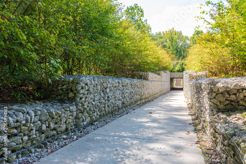 Footpath in the park, Environmental object, gabion fence wall from steel mesh with stones
