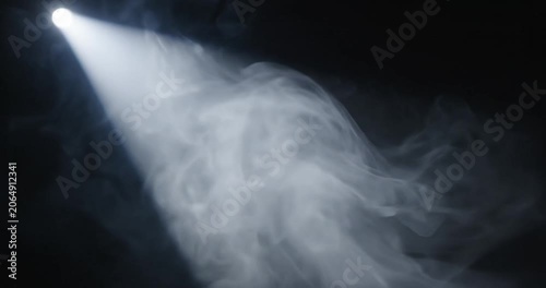 spotlight beam shining through smoke.