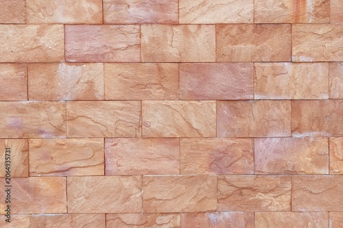 close up of stone wall brown mosaic tiles of background.