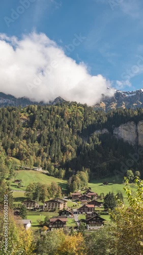 Lauterbrunnen Switzerland time lapse at village valley in autumn season and Mannlichen peak (vertical)