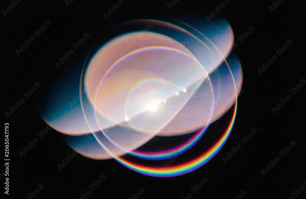 Naklejka premium Overlapping circular light flares with chromatic aberration against a dark background circles flare lights optical phenomenon refraction reflection