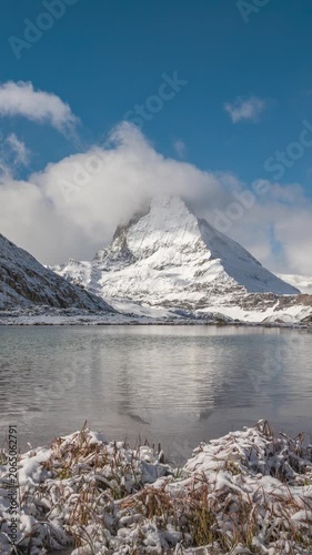 Zermatt Switzerland time lapse at Matterhorn mountain peak and Riffelsee lake in winter season (vertical)