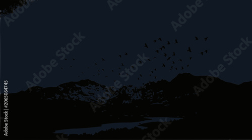 Flock of Birds Flying Over Dark Mountains at Dusk