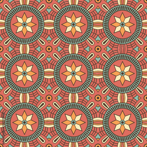 Seamless geometric mandala vector pattern with floral ornaments and ethnic symmetry. Colorful decorative color background in boho and folk style. For wallpaper, textiles, wrapping paper.