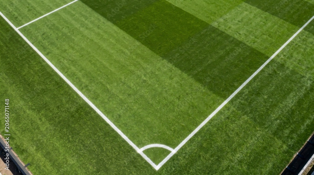 Obraz premium Corner of a green soccer field with white lines soccer background