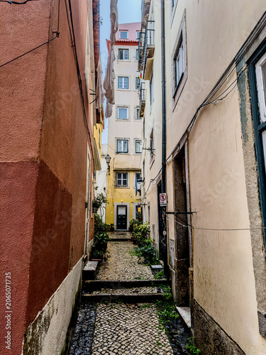 Colourful facades in a narrow alley in the old town of Lisbon, Portugal.