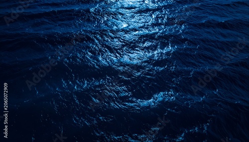 Night ocean water texture with subtle moon reflections, uniform dark blue wave patterns, premium marine background, top-down perspective