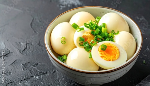 Boiled eggs in a bowl with herbs.