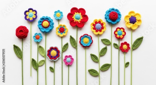 Crocheted flower garden with green stems on white background.