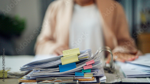 Tableau sur toile Blurry person sits at desk, hands resting nearby