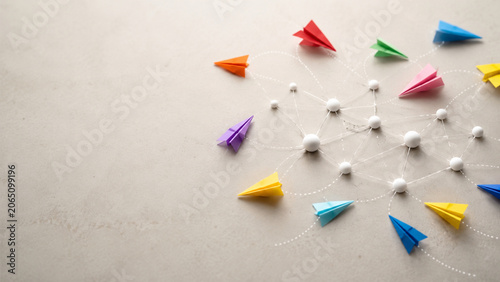 Colorful paper planes flying through abstract network nodes
