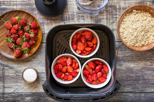 Step 5. Cooking english crumble cake with strawberry in kitchen gadget modern air fryer. Lifestyle trendy of new cooking.